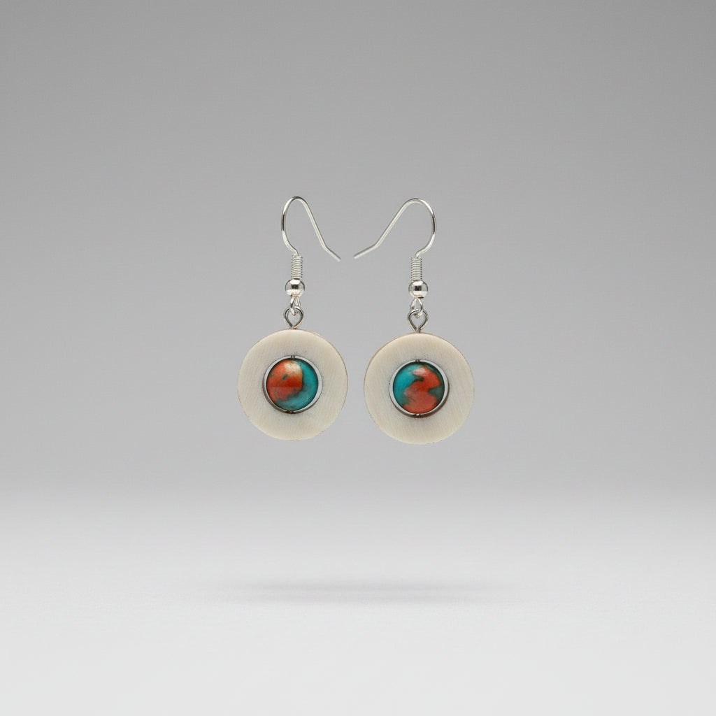 Natural deer antler earrings with circular design featuring orange and turquoise semi precious gems on a gray background