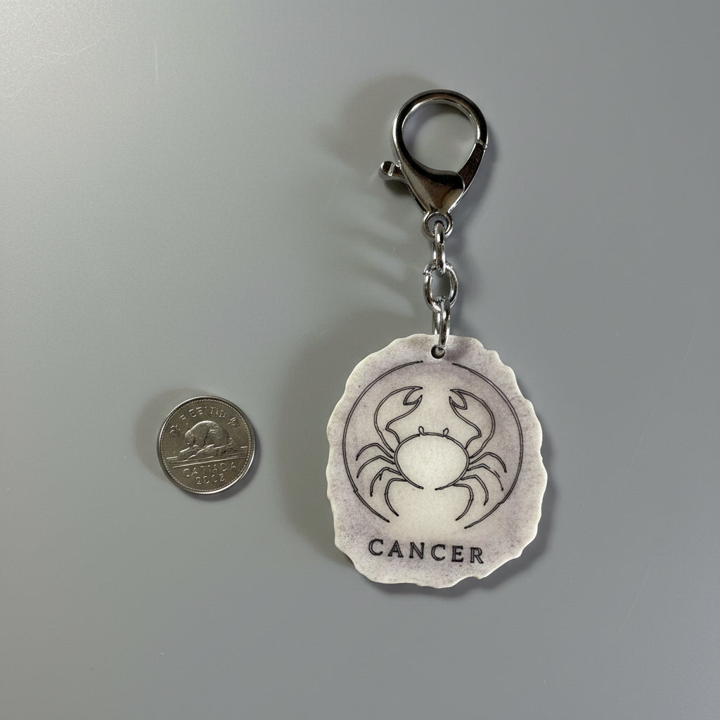 Other side of a moose antler zodiac sign keychain on a gray background