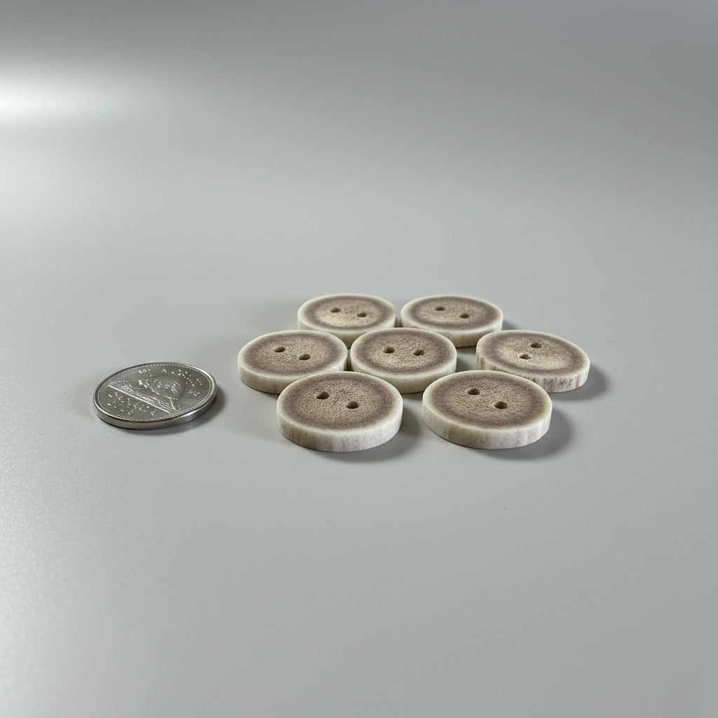 Deer antler buttons on a gray backround