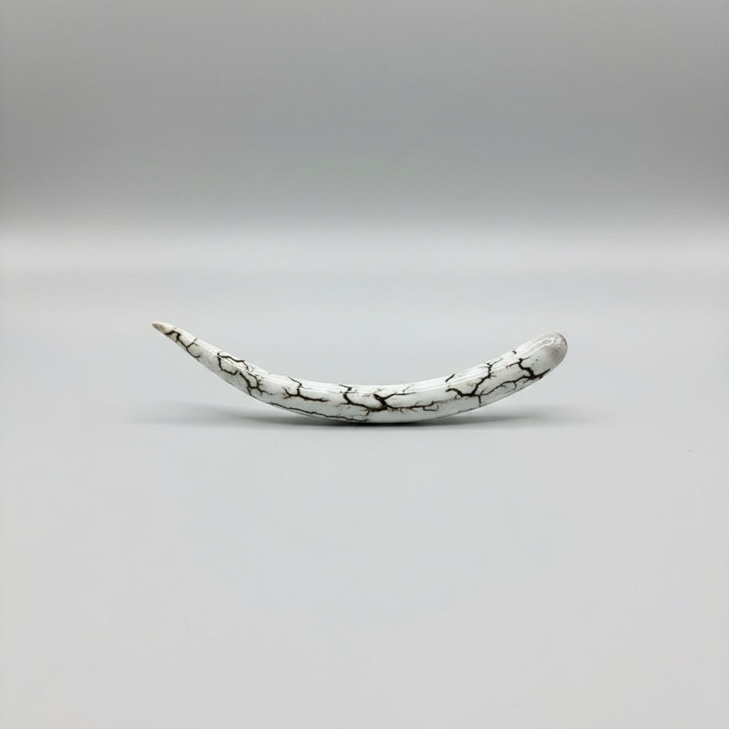 bottom vie of the natural deer antler hair pin polished on a gray background