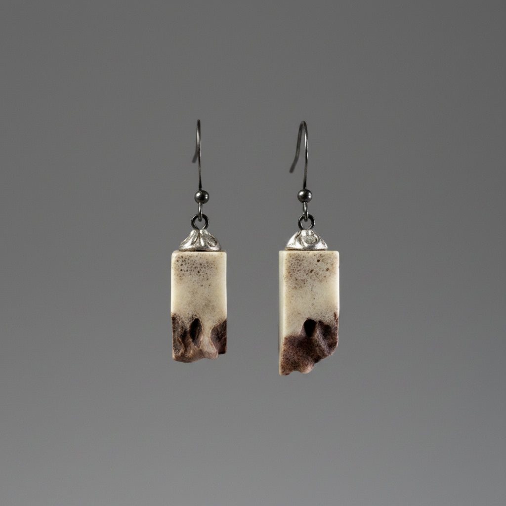 Elk antler earring on a gray background