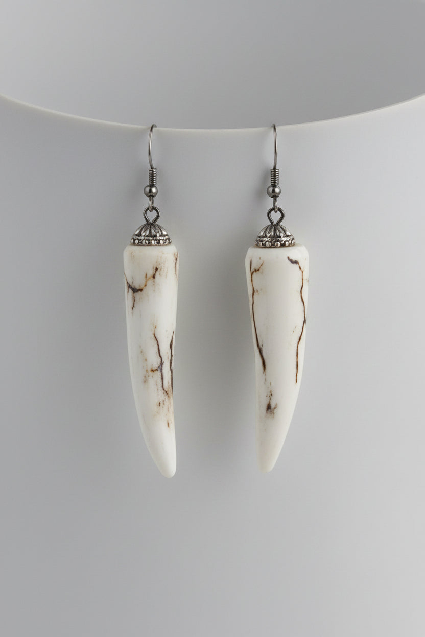 Pair of deer antler tip earrings on a gray background