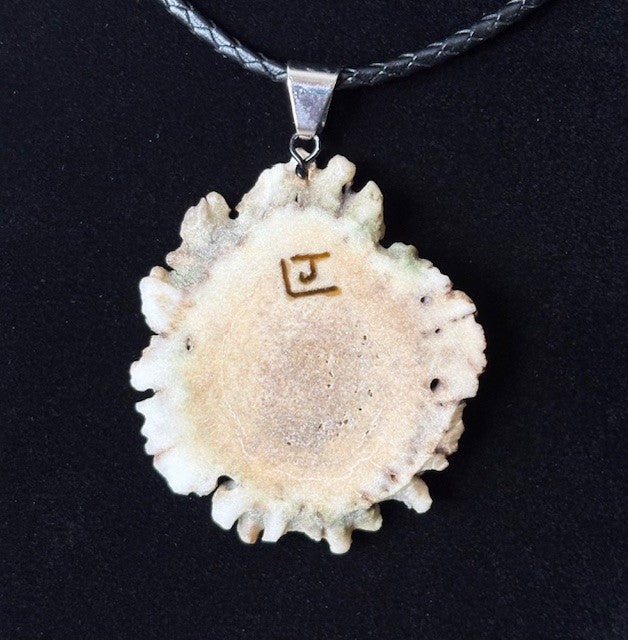 Back view of Necklace with a pendant featuring an arrowhead design on a black background