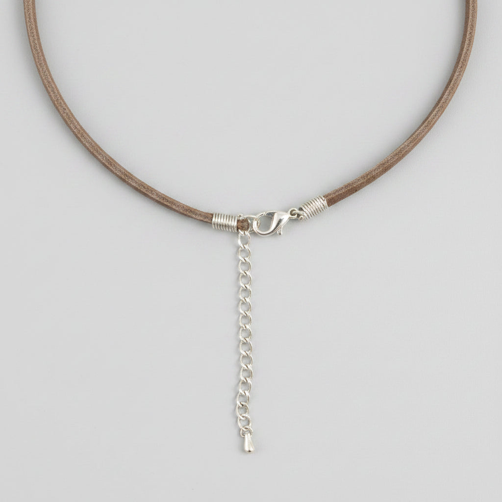 Close-up of a silver chain necklace on a gray background