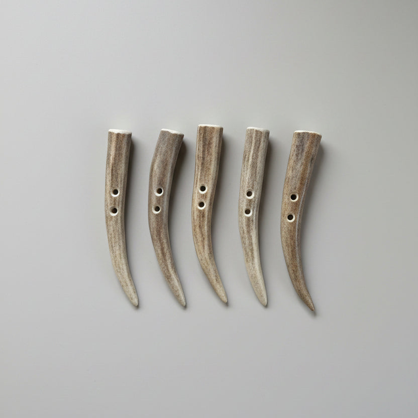 Deer antler toggle buttons on a gray background