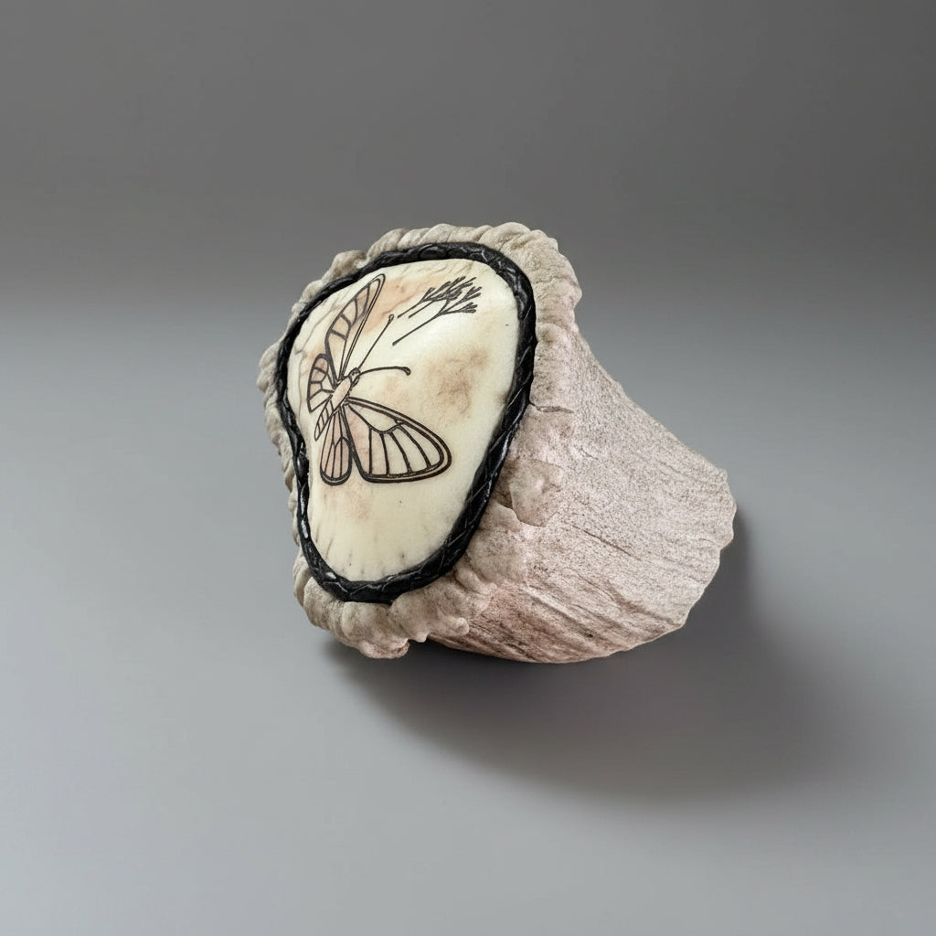 Other side of the elk antler cornet on a gray background