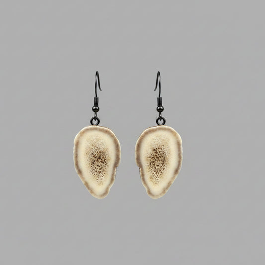 Deer antler earring on a gray background