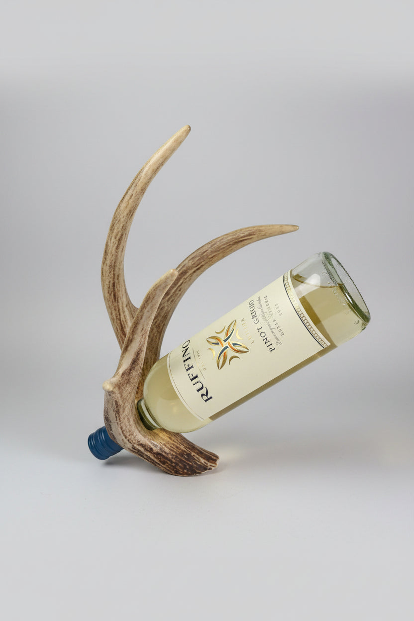 Wine bottle on a decorative antler bottle holder on a gray background