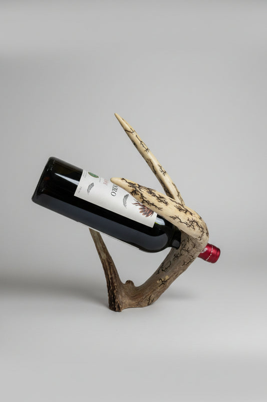Mule deer antler bottle holder on a gray background