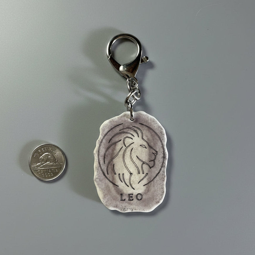 Moose antler zodiac sign keychain on a gray background
