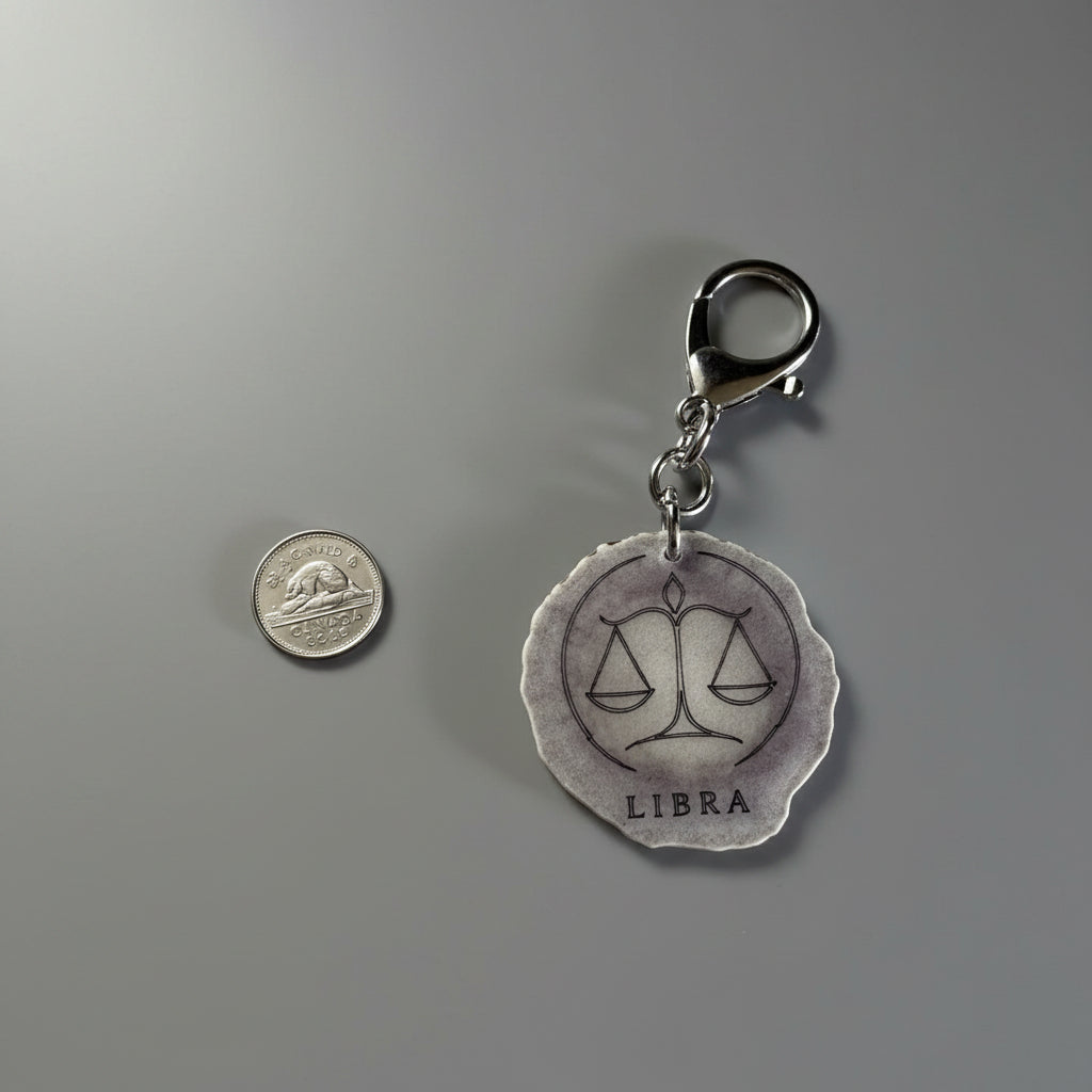 Moose antler zodiac sign keychain on a gray background