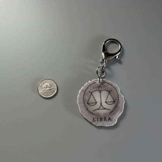 Moose antler zodiac sign keychain on a gray background