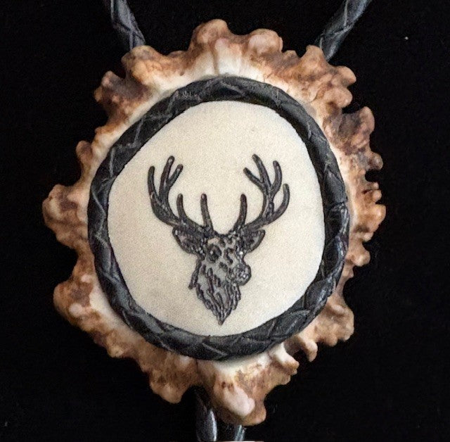 bolo tie featuring a deer head design on a black background