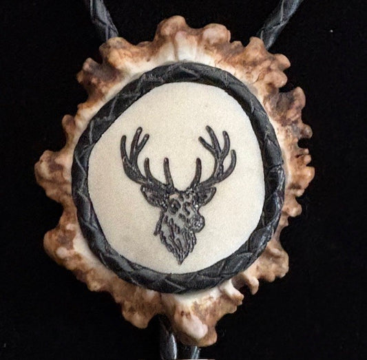 bolo tie featuring a deer head design on a black background