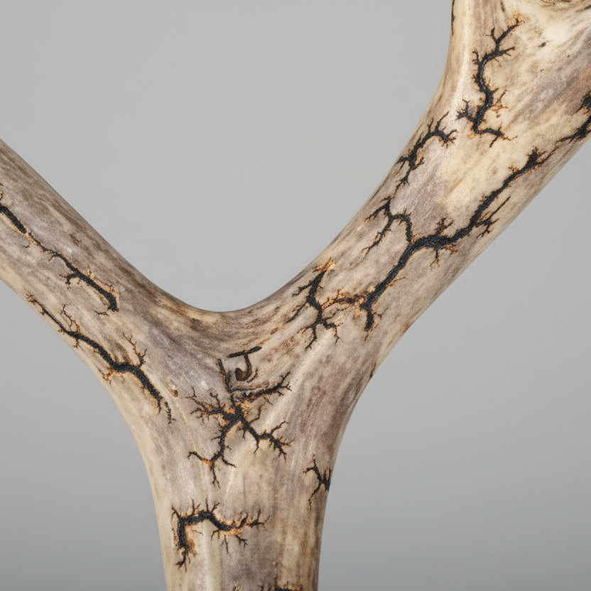 Signature in the back of deer antler  cribbage board on a gray background