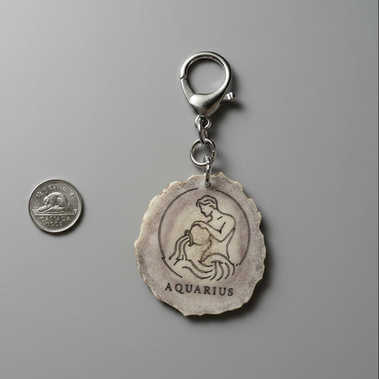 Moose antler zodiac sign keychain on a gray background