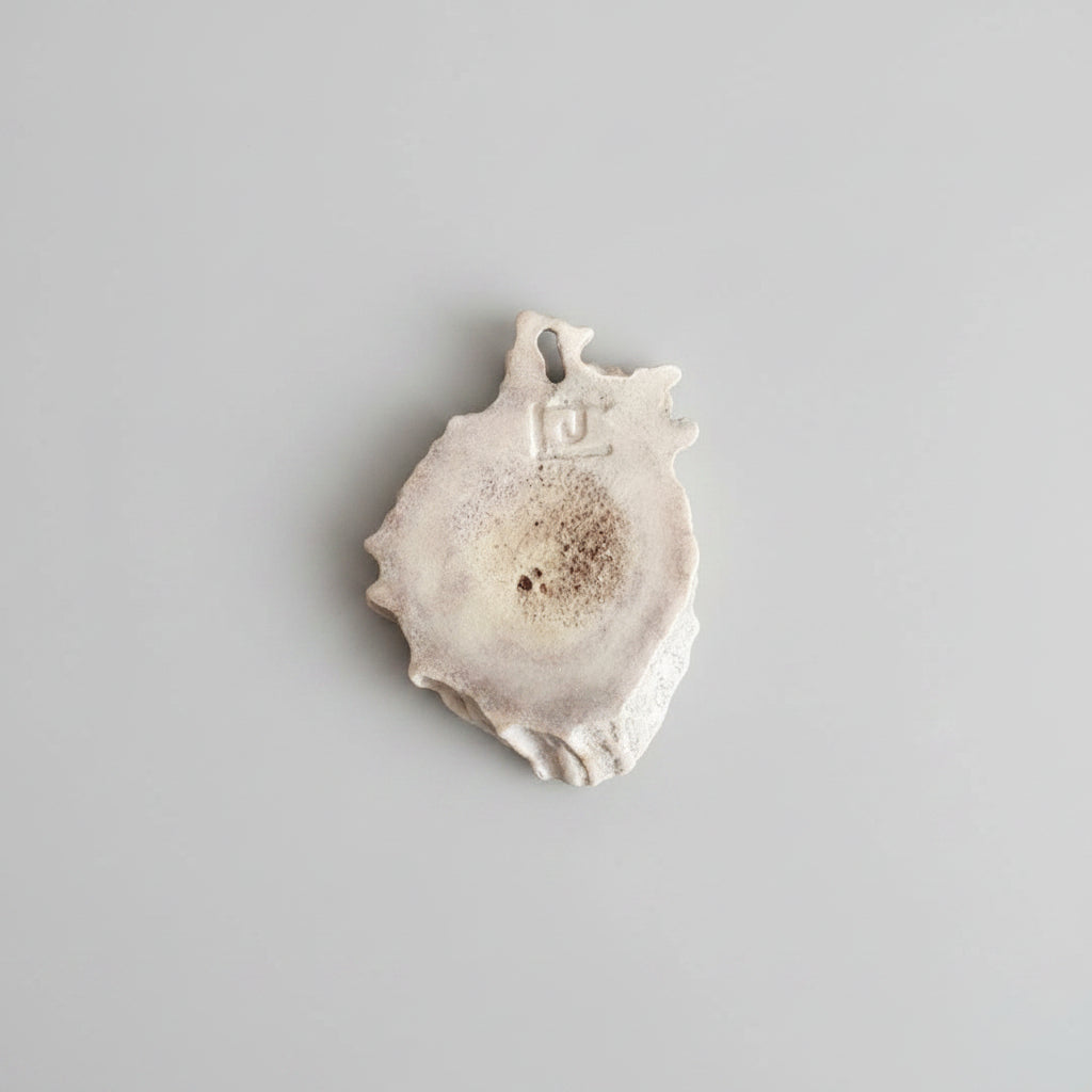 bottom view of the Aroma diffuser antler piece on a gray background