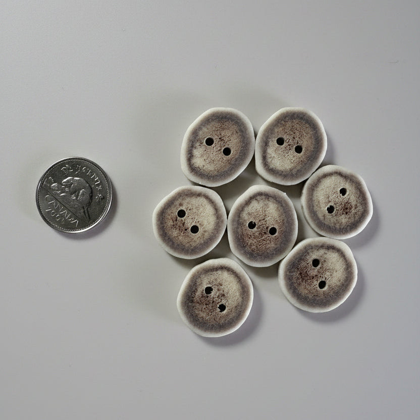 Deer antler buttons on a gray background