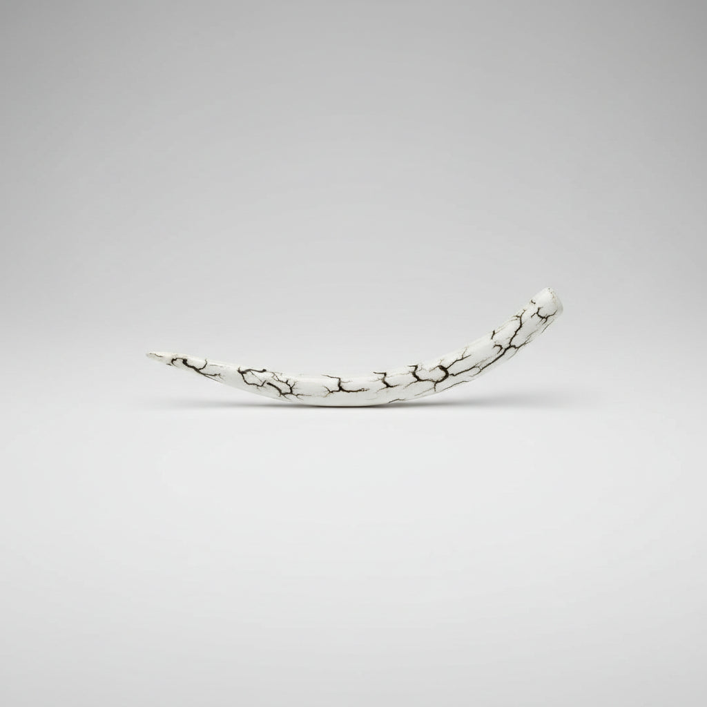 side view of the natural deer antler hair pin polished on a gray background