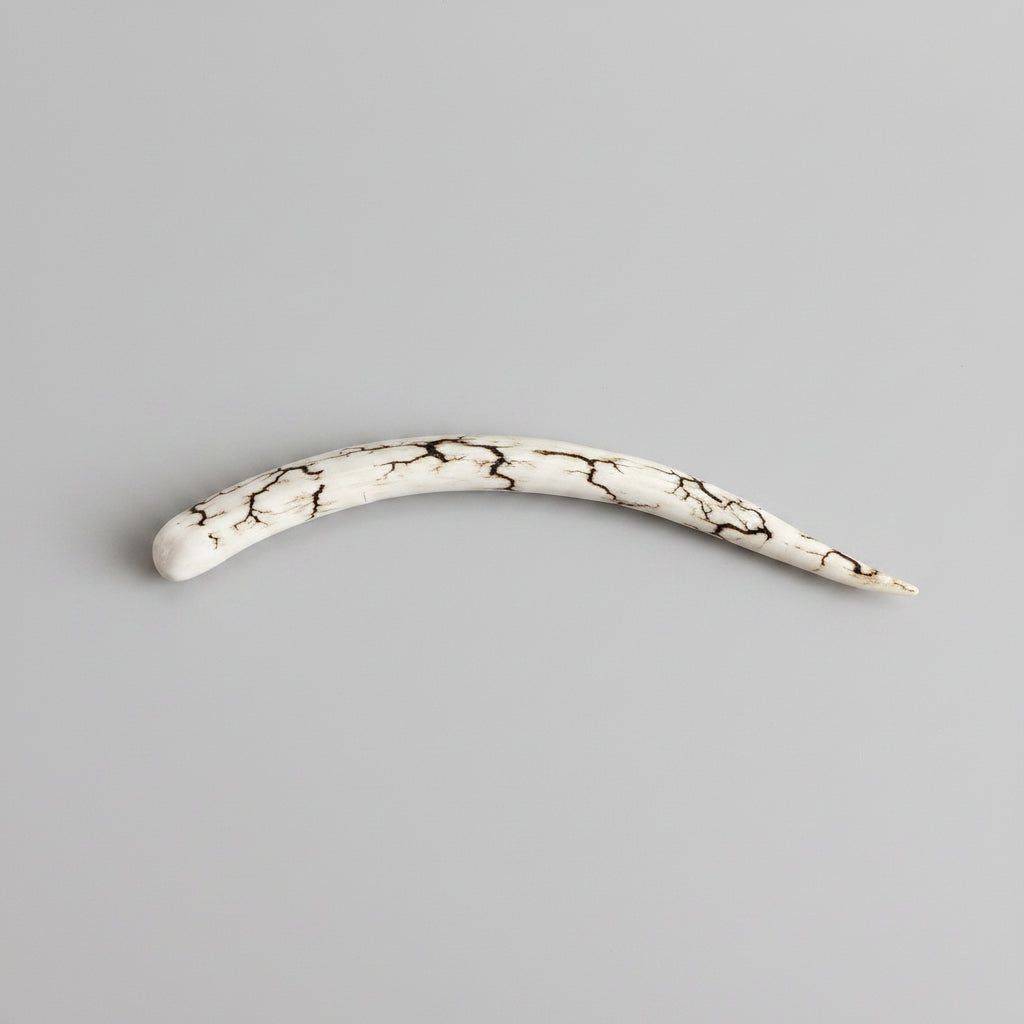 natural deer antler hair pin polished on a gray background