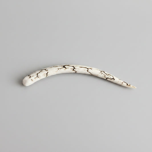 natural deer antler hair pin polished on a gray background