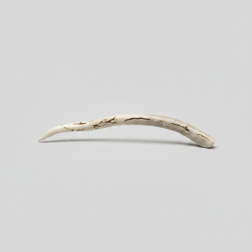 Deer antler hair pin with black strike on a gray background