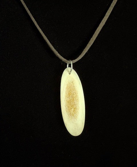 Necklace with a deer antler slice pendant on a black background