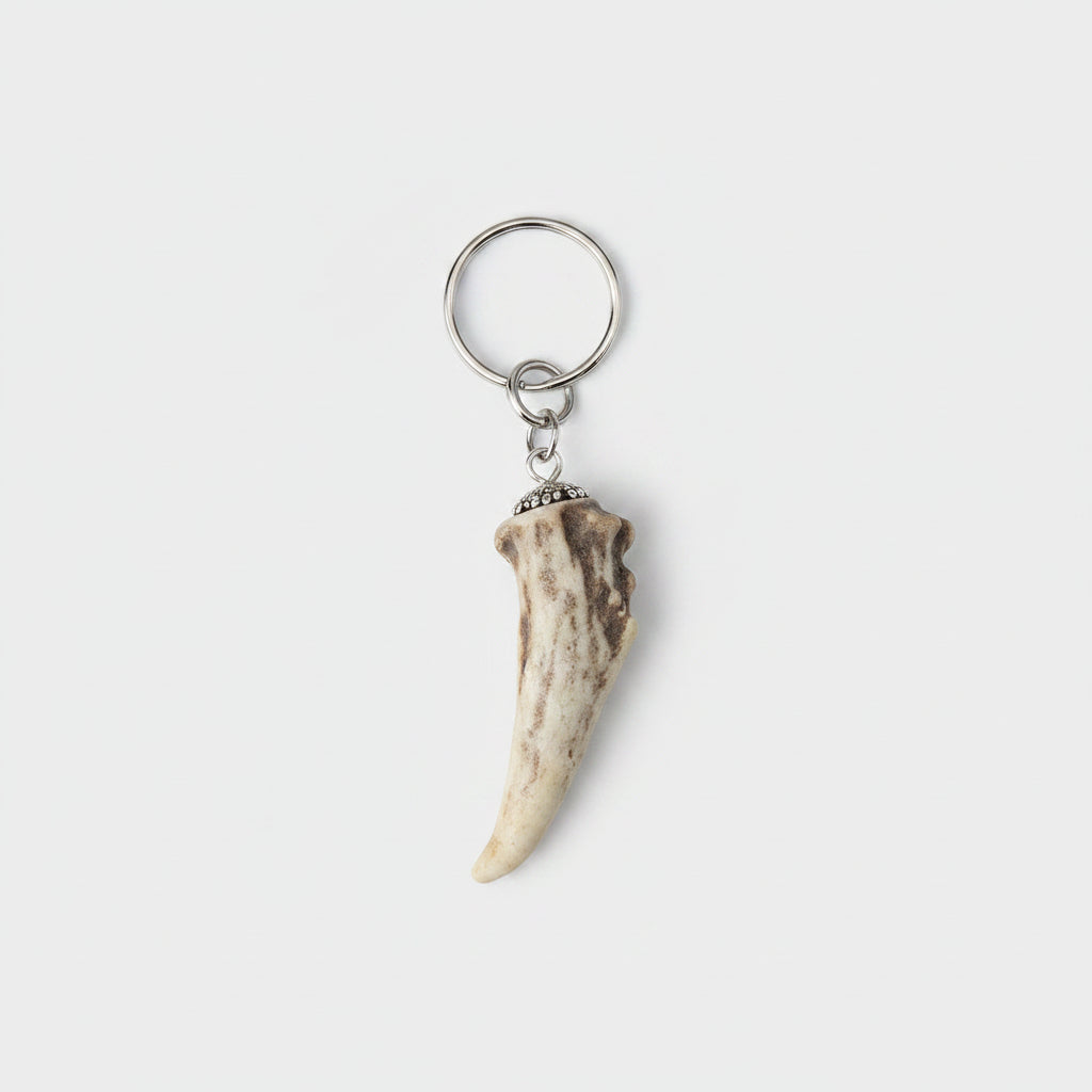 deer antler tip keychain on a gray background