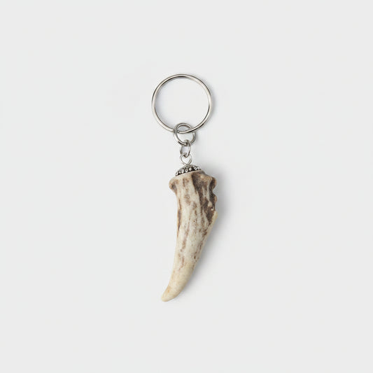 deer antler tip keychain on a gray background