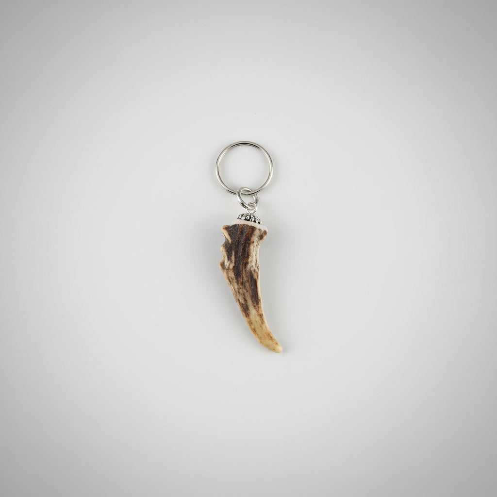 deer antler tip keychain on a gray background