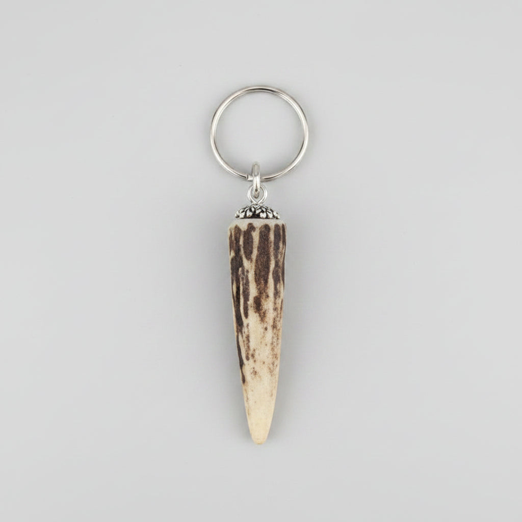 Natural deer tip keychain on a gray background