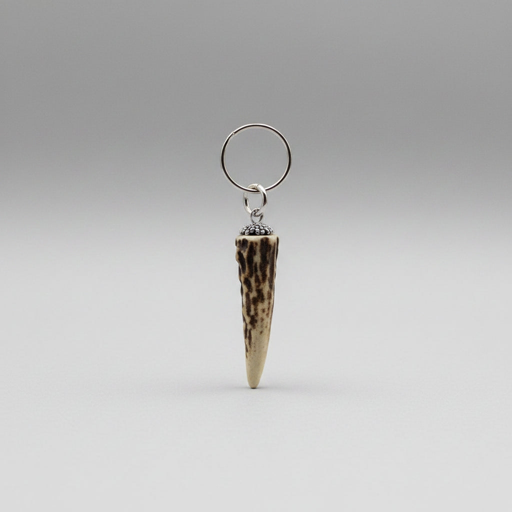 Natural deer tip keychain on a gray background