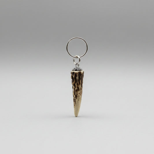 Natural deer tip keychain on a gray background
