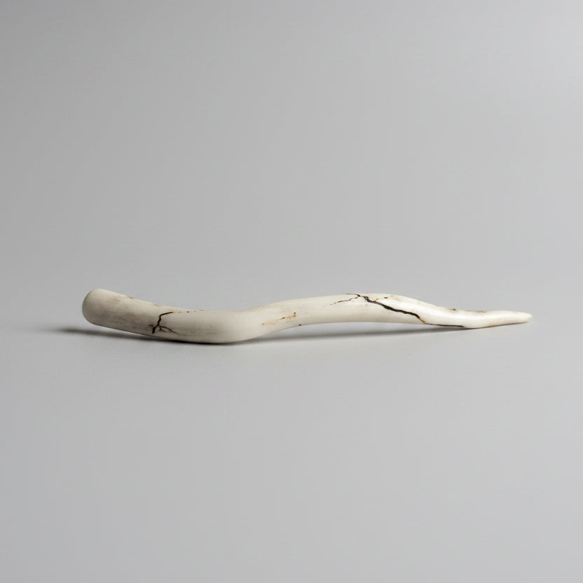Deer antler hair pin with black strike on a gray background