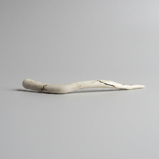 Deer antler hair pin with black strike on a gray background