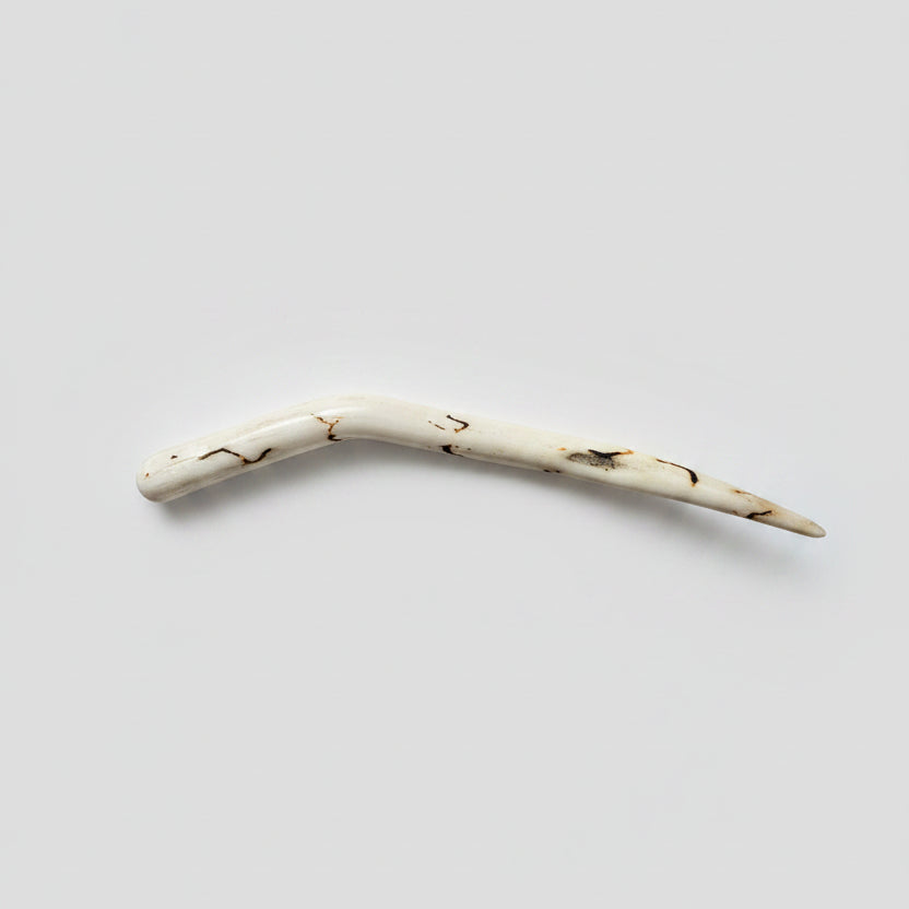 Deer antler hair pin with black strike on a gray background