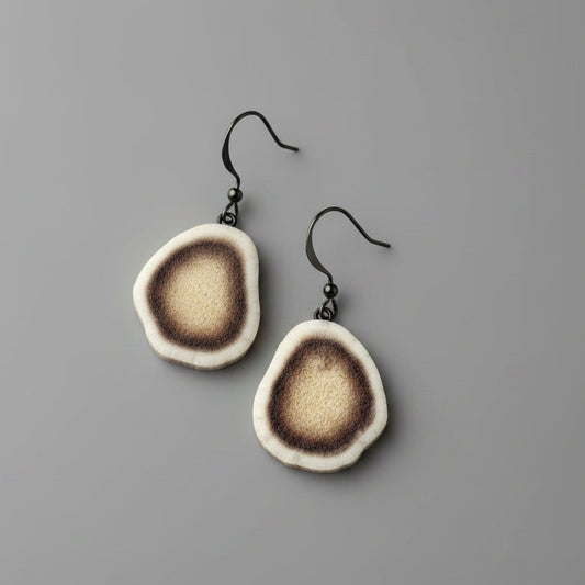 Deer antler earring on a gray background