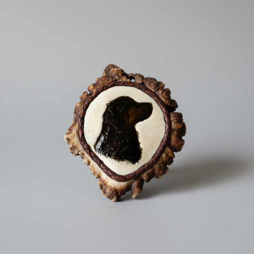 elk antler cornet with a dog head carved and inlayed on a gray background