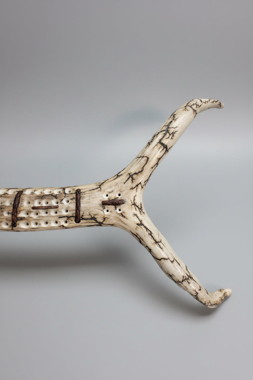 Top end of the elk cribbage board on a gray background