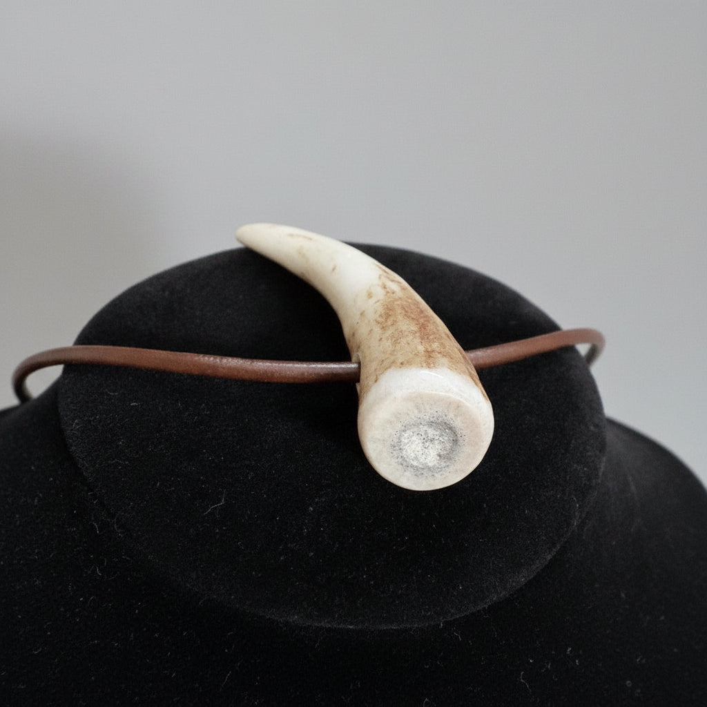 top view of the elk antler tip necklace with aroma diffuser on a gray background 