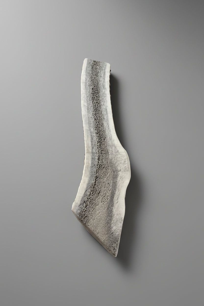 other side of the split elk antler dog chew on a gray bckground