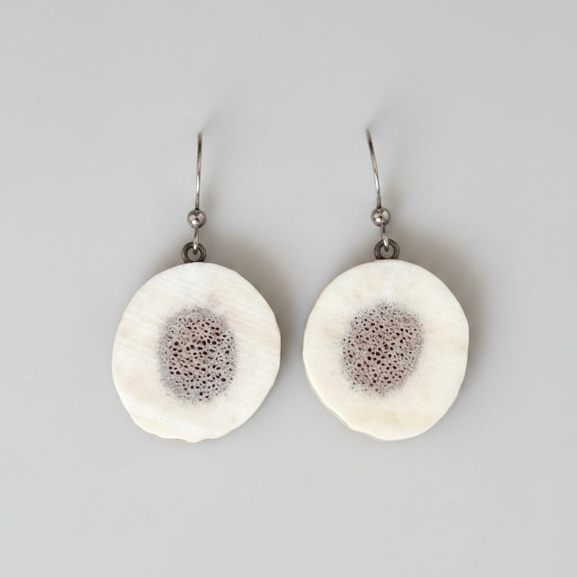 Natural Elk antler earrings on a gray background