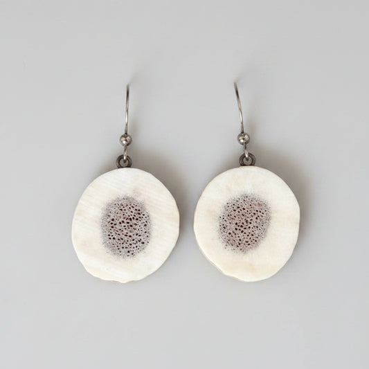 Natural Elk antler earrings on a gray background
