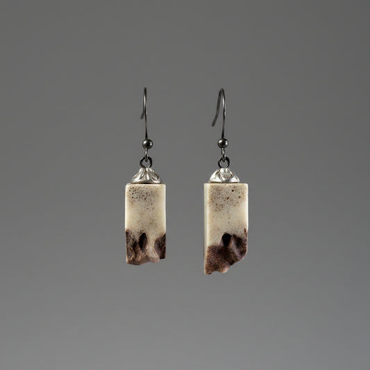 Elk antler earring on a gray background