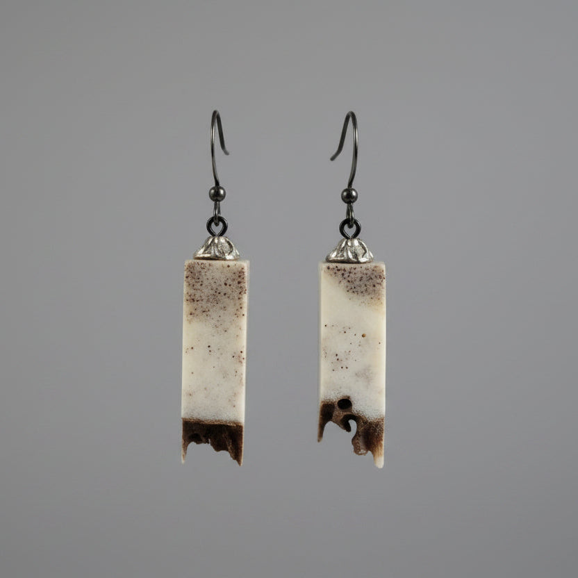 Elk antler earring on a gray background