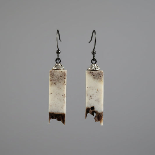 Elk antler earring on a gray background