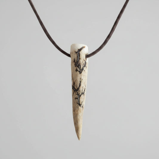 Deer antler tip necklace with aroma diffuser on a gray background 