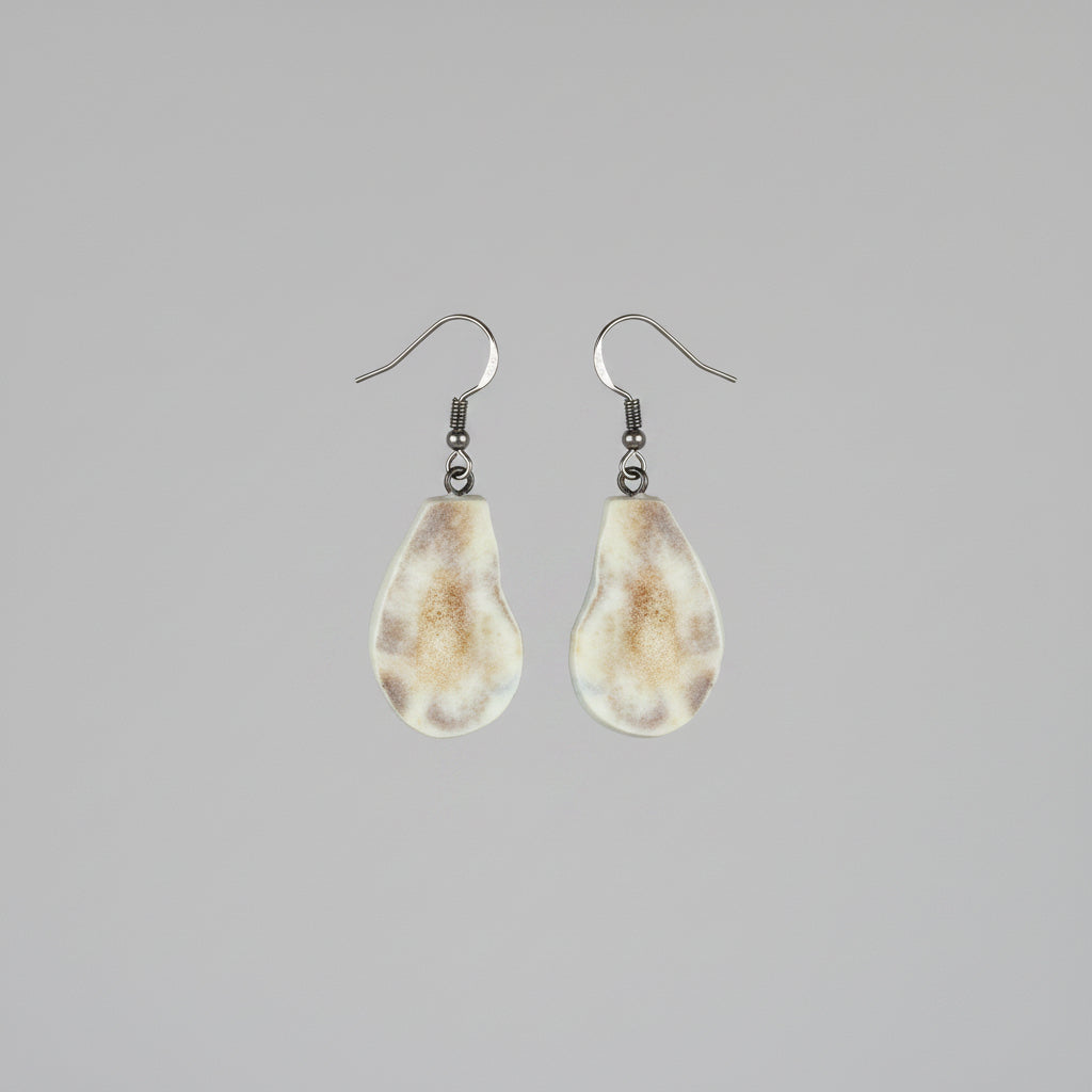 Natural deer antler earrings on a gray background