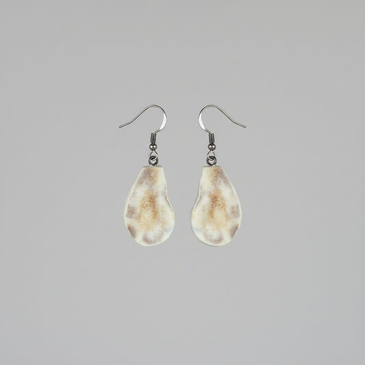 Natural deer antler earrings on a gray background