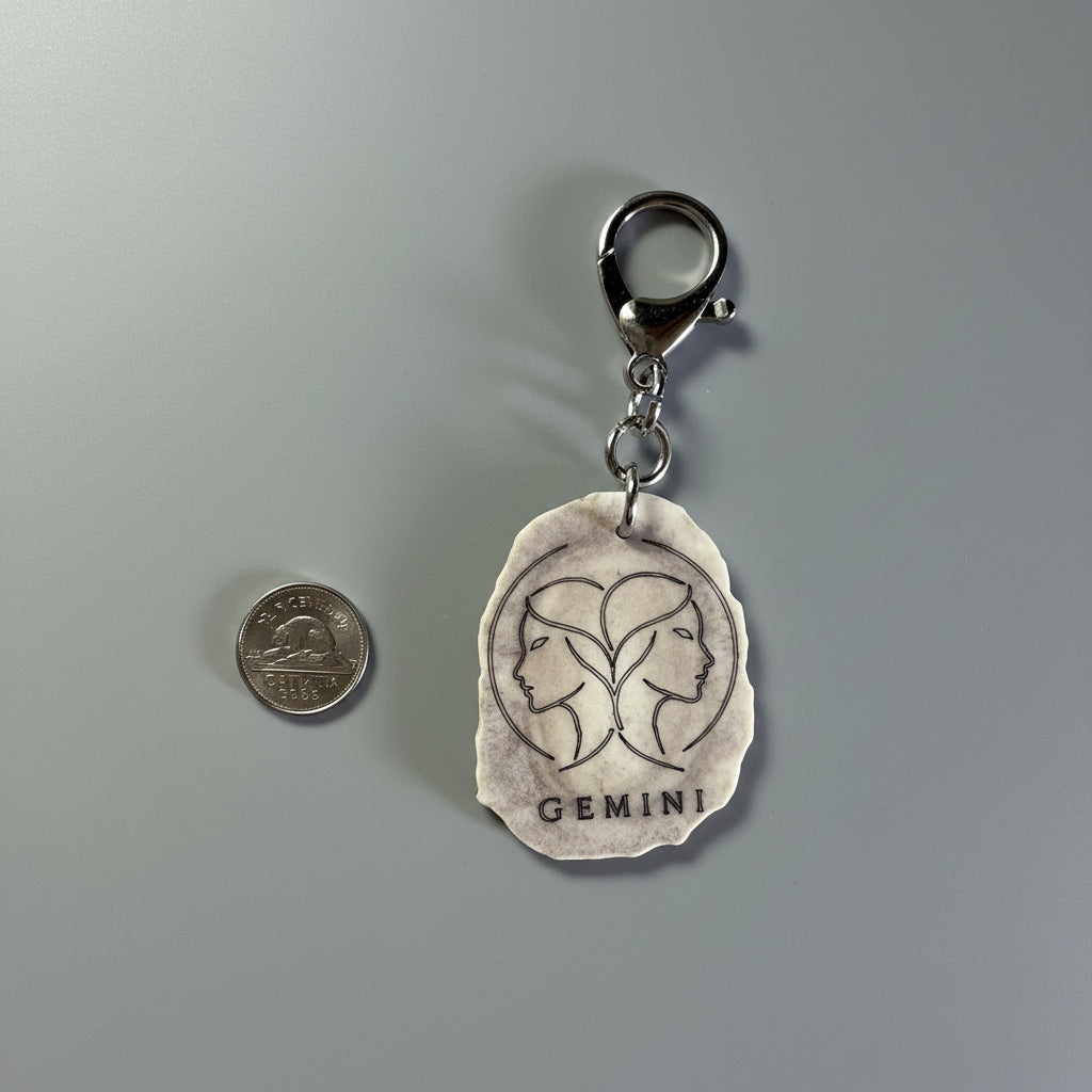 Moose antler zodiac sign keychain on a gray background